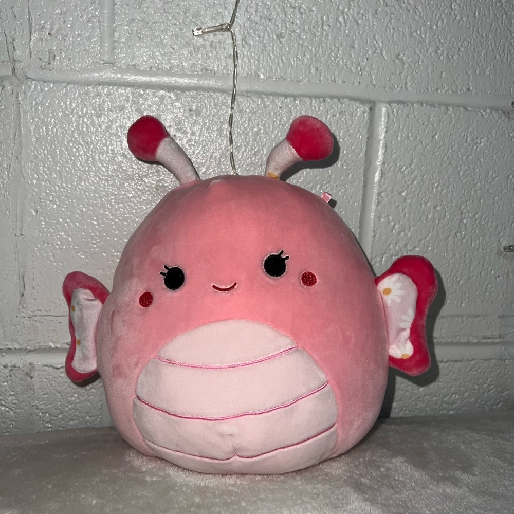 Pink butterfly with flowers designs in the wings